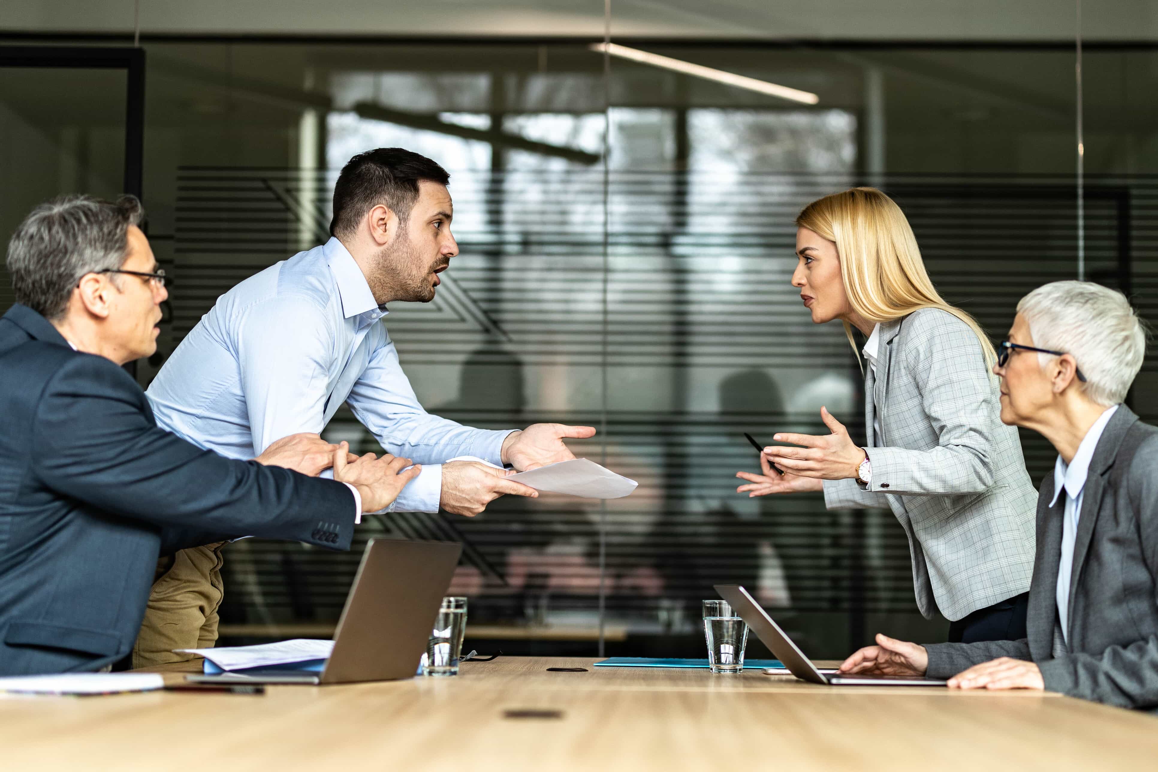 Couple arguing in front of lawyers